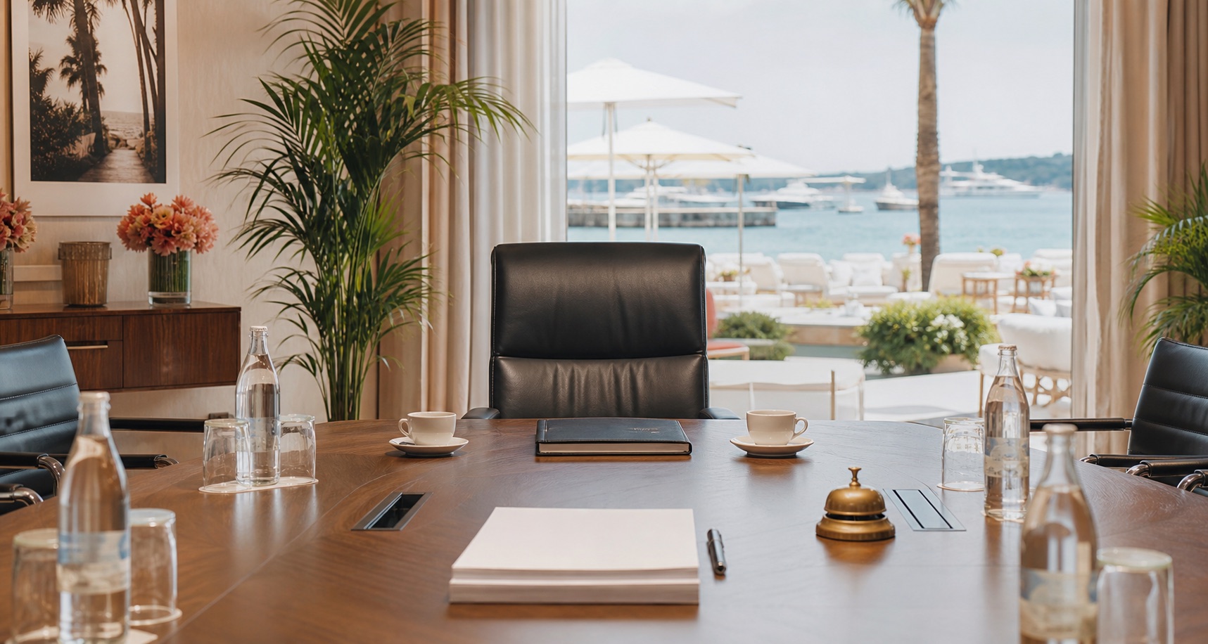 A quiet Cannes beachfront meeting room with an empty chair at the head of the table